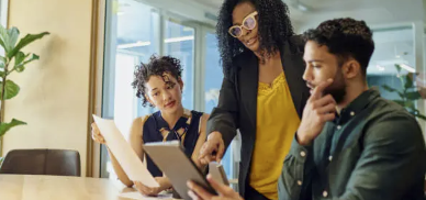 Three women meeting about information on a laptop